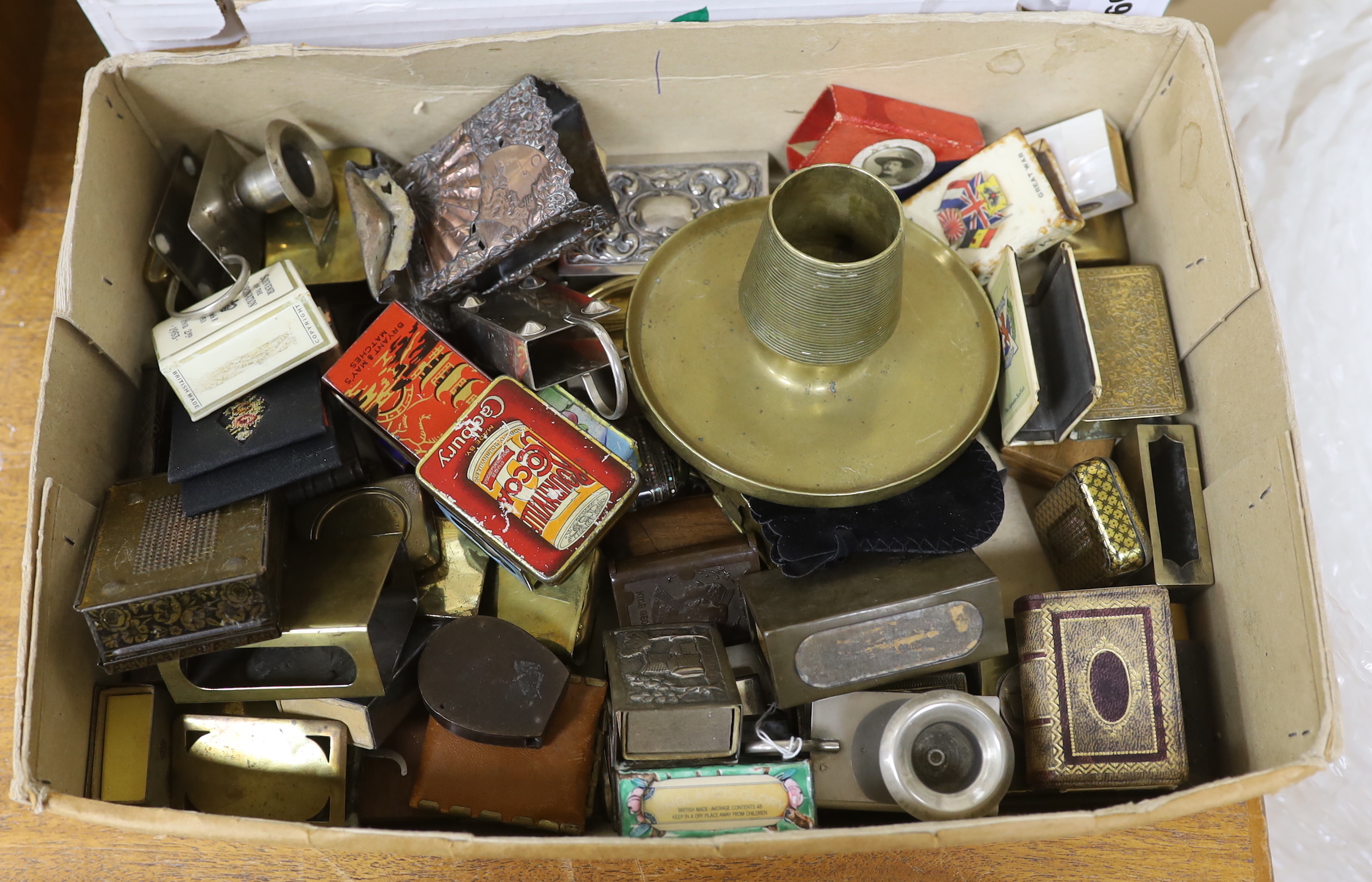 A collection of Vesta boxes, matchbox holders and other related ephemera, mostly metal examples, some with enamel panels, candle holders, wooden boxes, together with a rabbit pipe rack, tobacco jars, cigarette cases, etc